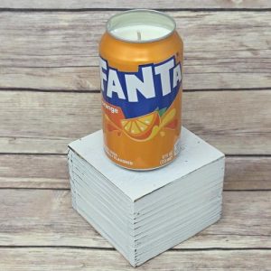 Upcycled Fanta Orange Soda can holding a soy wax candle
