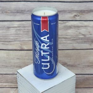 An upcycled Michelob Ultra can holds a soy wax candle.