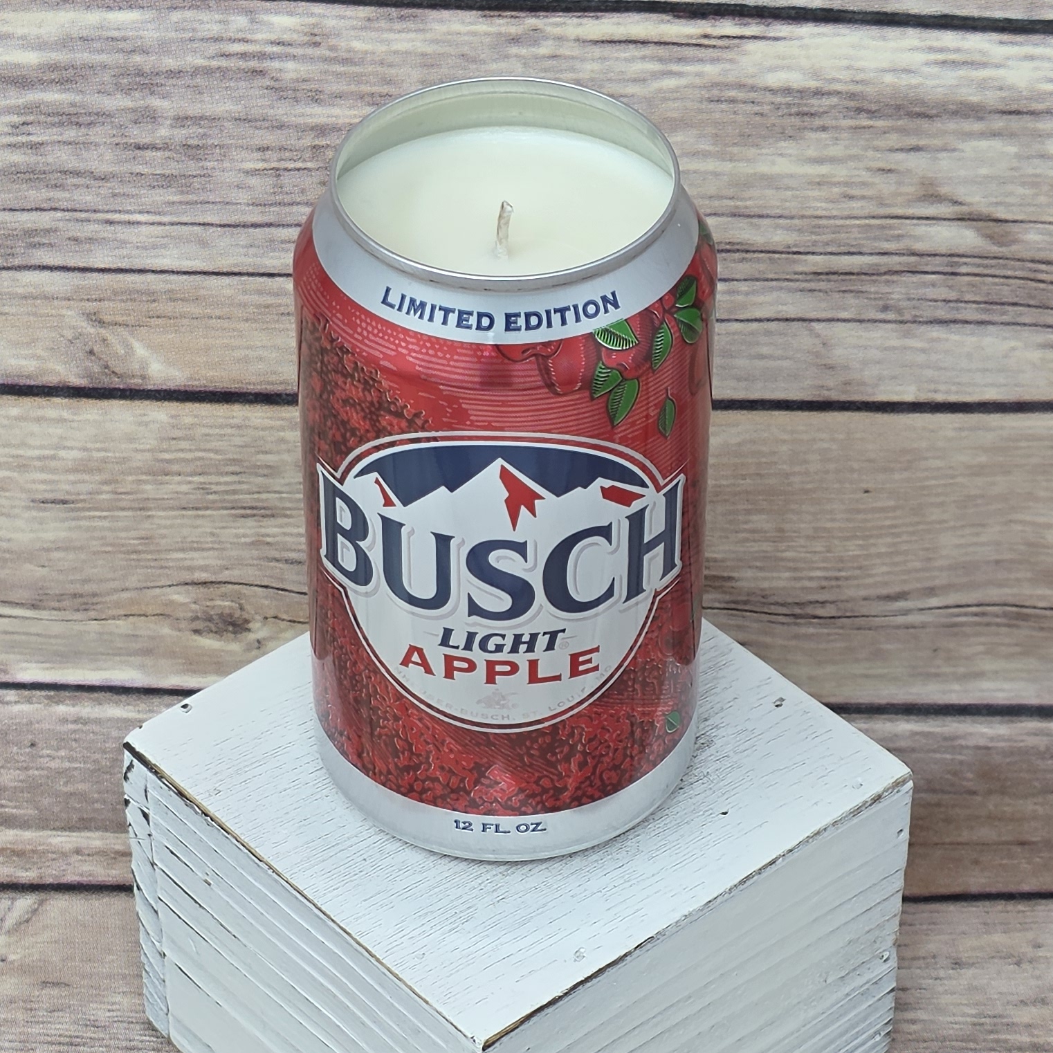 Upcycled Busch Light Apple cans hold a soy candle ready to burn.